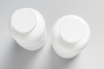 Set of plastic shampoo, cosmetics bottles on grey background