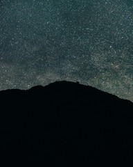 winter landscape with mountains. landscape with stars. man on the background of stars