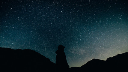 winter landscape with mountains. landscape with stars. man on the background of stars