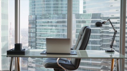 Office with panoramic windows over city landscape. Wardrobe against the background of panoramic windows in a skyscraper.