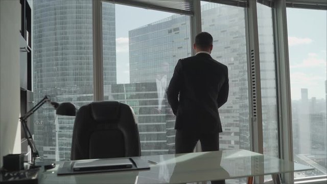 Office with panoramic windows over city landscape. Wardrobe against the background of panoramic windows in a skyscraper.