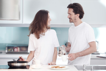 Couple cooking breakfast together