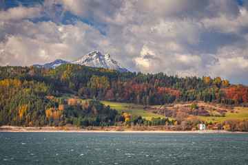 A snowy hill called Choc over The Liptovska Mara dam in autumn season, the area of Liptov in Slovakia, Europe.