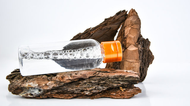 Perfume in tree bark with drops of water. texture. concept of freshness and naturalness. the aroma of wood and morning dew. autumn melancholy. copy space