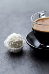 Sweet dessert and Coffee in glass cup on darkt stone background. Close up.