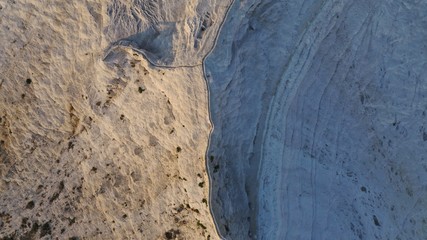 Aerial view of thermal pools hot springs tavertine terraces of Pamukkale natural park, white cotton castle, snow white mountains with carbonate mineral milky pools, Turkey
