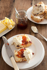 Fresh buttered rock cake with cream and fruit jam