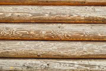 Old distorted boards in a row on the wall. Texture of natural rough boards.