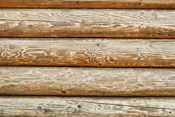Obraz premium Old distorted boards in a row on the wall. Texture of natural rough boards.