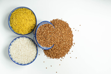 Three bowls with different types of cereals on a white background