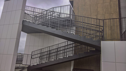outdoor staircase with railing near the building
