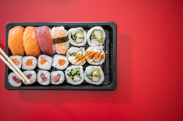 Japanese food. Sushi set on red background. Top view. Copy space