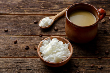 Bulletproof coffee with butter, recipe for ketogenic diet on a wooden background