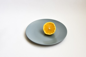 sliced lemon on a plate on a white background