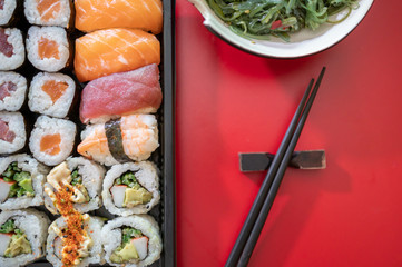 Delicious japanese food isolated on red background.Delivery service.Top view.