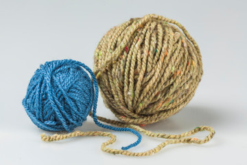 two balls of yarn, blue and beige