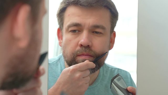 Man makes haircut of beard razor. beauty salons are closed because of pandemic