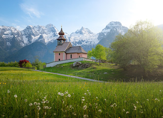 Idyllic pilgrimage church with snow-capped mountains in the background