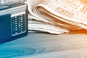 Radio and newspapers on the office desk, media breaking news concept.