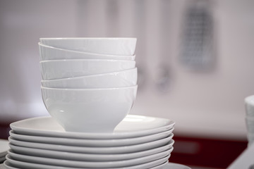 Commercial white plates bowls with blurred background at the kitchen