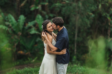 Young latin american couple with amazing view of Ubud rice terraces in morning. Happy together, honeymoon in Bali. Travel lifestyle.