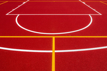 Red background of newly made outdoor basketball court