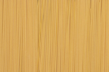 Fototapeta premium Yellow long spaghetti as background. Food background concept.