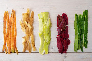 vegetable peels on white wooden background, compost concept, recycling of food waste