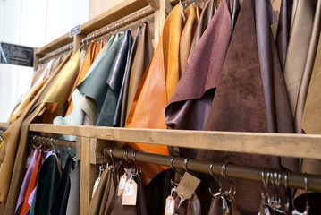 Bokeh image of leather material shelf in craft shop