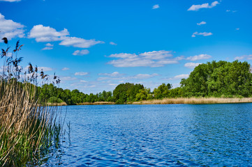 Blue and cloudy sky over a lake in the near of Sperenberg, Germany.