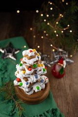 Baked gingerbread christmas tree on wooden background. Close-up