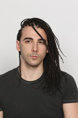 Stylish male model with afro braids posing in studio on isolated background. Style, trends, fashion...
