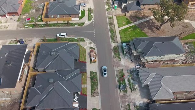 Melbourne Australia Aerial Drone View following a car on the road in Suburb Houses, new resident, new homes