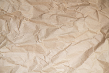 Background with the texture of uniformly crumpled Kraft paper.