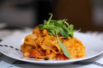 Fettuccine with shrimps recipe: white wine, olive oil, saffron, arugula, chilli, anchovies, garlic, cherry tomatoes, lemon, onion, toamto, shrimps and fettuccine.
