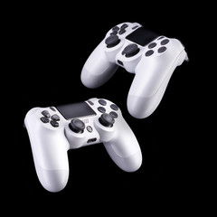 Set of white video game joysticks gamepad isolated on a black background