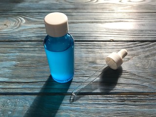 bubble with serum and a dropper in the sunlight. cosmetics for care