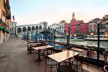 Venice in Italy - Rialto Bridge and Grand Canal with empty embankment,  tourist centre of famous city without people