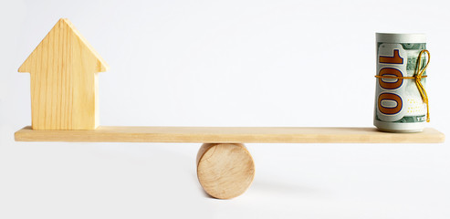 Seesaw Showing Balance Between money And House Model