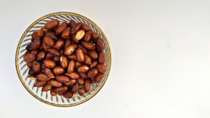 Top view of Roasted peanuts in glass bowl, Isolated on white background.
