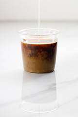 cup of hot coffee on white marble table background.