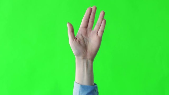 Female hand Vulcan greeting on green screen