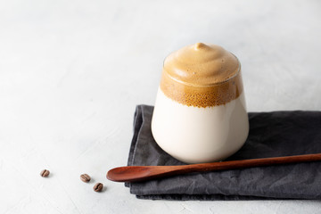 Dalgona iced coffee or whipped instant coffee. Trendy drink. Light background. Space for text.