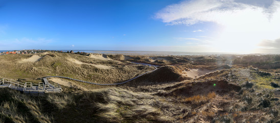 North Sea dunescape panoramic view in Amrum island with view of Wittduen village