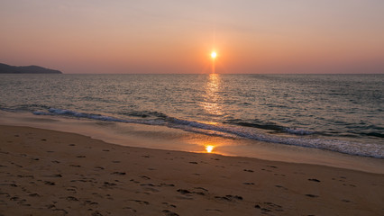 Sunset and reflection of sun on a beach - Phuket / Thailand