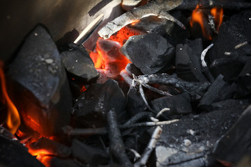 Fire with coals on a picnic . Preparing coals for cooking meat. Outdoor activities. 