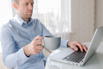 A man with a cup of coffee and notebook