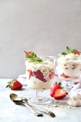 Eton mess - traditional english dessert with meringue, whipped cream and fresh berries.