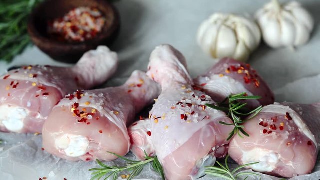 Cooking chicken legs with spices, garlic and rosemary. Cooking food concept.