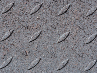 Rusty metal plate. Floral motifs on metal background. Abstract surface.Close up.